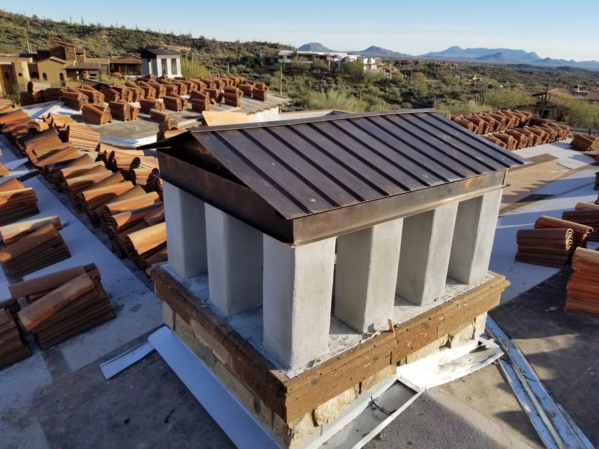 Custom copper chimney cap on rooftop — architectural metalwork Scottsdale AZ