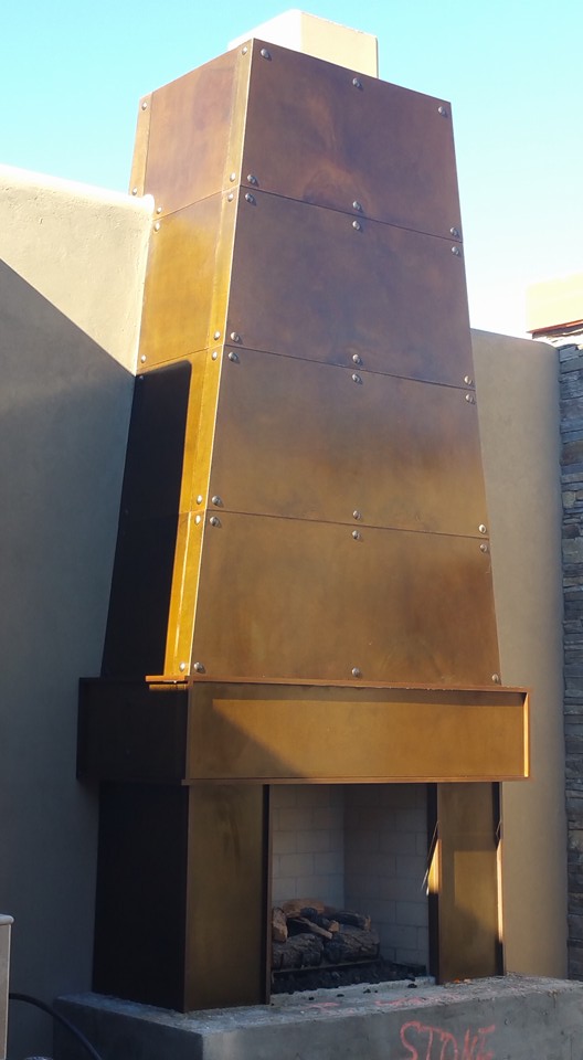 Patinated copper fireplace surround — riveted panels