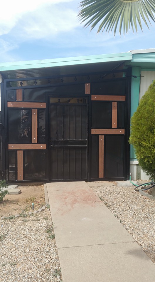 Modern steel gate with screen panels and wood accents — custom gates Arizona