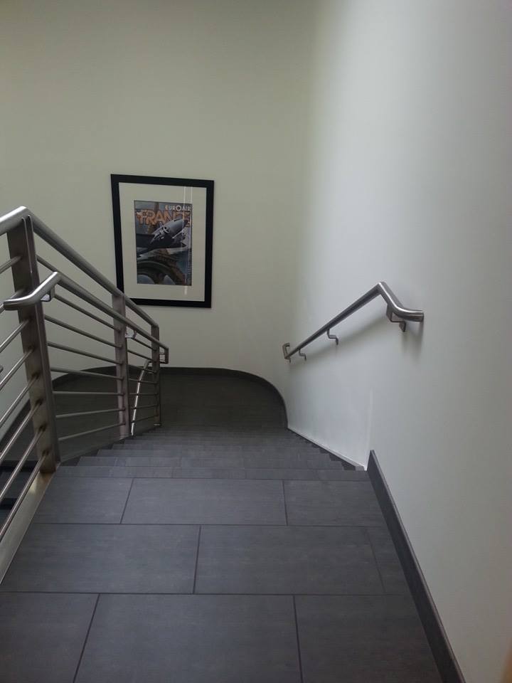 Stainless steel stairwell railing with wall-mounted handrail — Phoenix AZ
