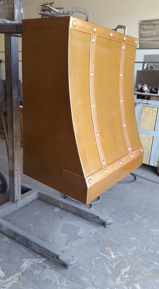 Curved copper range hood in fabrication shop — WeldDone Phoenix AZ
