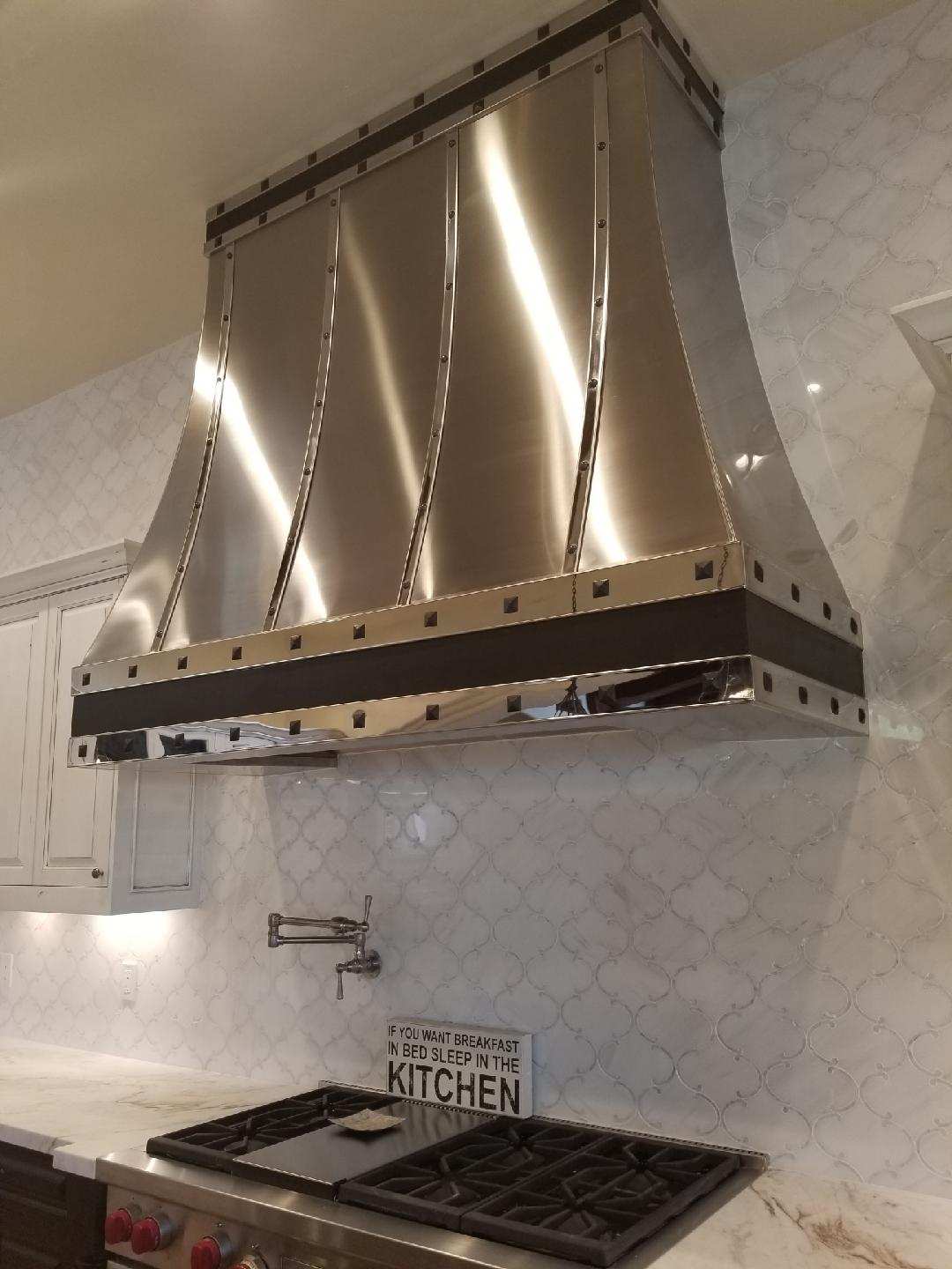 Polished stainless steel range hood with rivet detail — Phoenix AZ