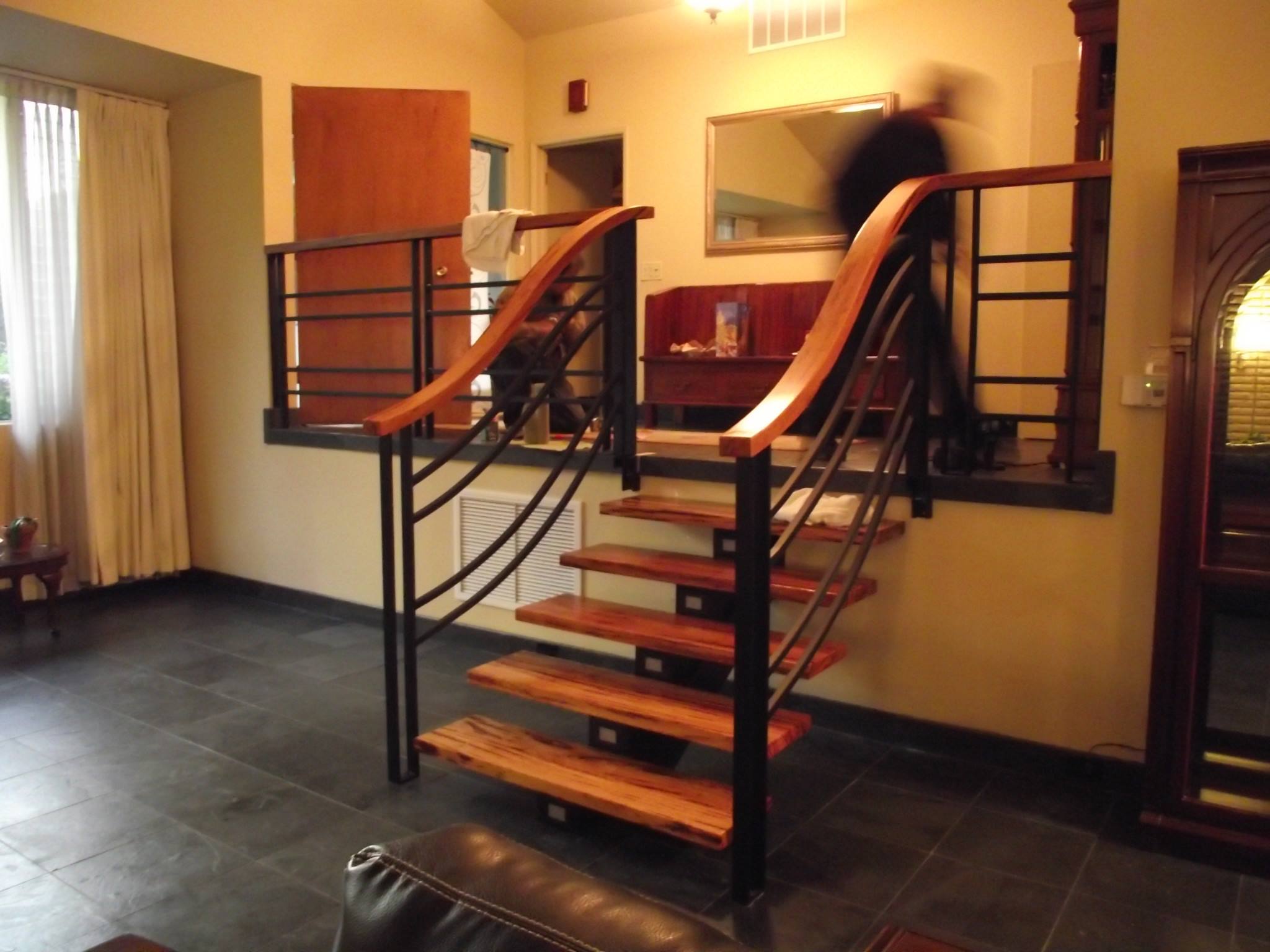 Custom steel staircase with wood treads and black metal railings